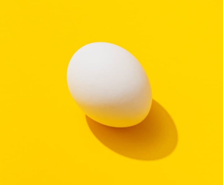 an image of an egg on a yellow background